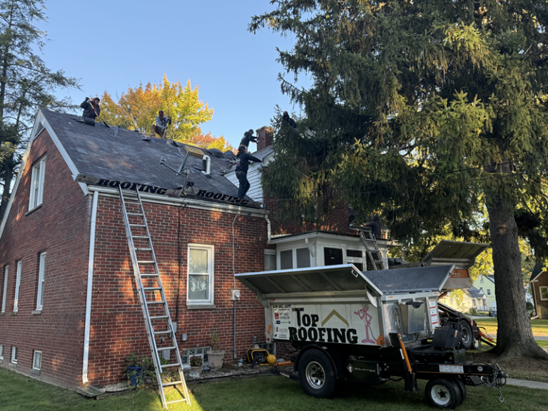 workers for top roofing doing a roof replacement