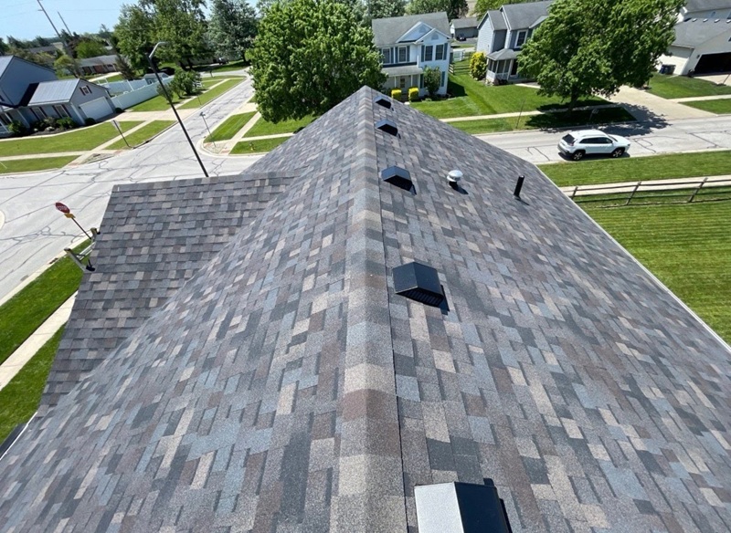 Gray shingle roof with vents showing how ventilation affects new roof cost in Toledo